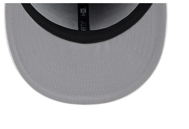 Close-up of the grey brim and inner lining of a NEW ERA 59FIFTY fitted hat.