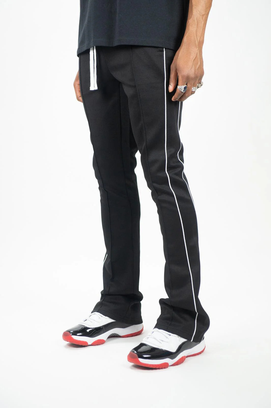 Rebel Minds black stacked fit track pants with white side stripes and drawstring.