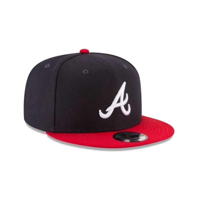 NEW ERA Atlanta Braves 9FIFTY Snapback hat in navy with a red visor and white team logo.